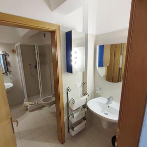 a bathroom with a sink and a shower and a toilet at Genziana Apartment - CIPAT 22114 in Marilleva