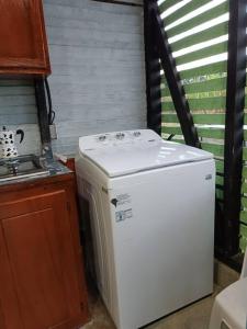 a white refrigerator in a kitchen next to a sink at Angostura Lodge 