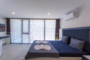 a bedroom with a blue bed with a bow tie on it at Angel Residence in Fethiye
