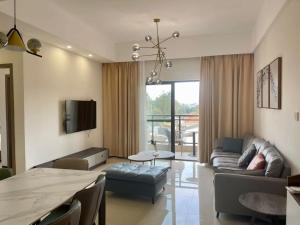 a living room with a couch and a table at Claire Aparthotel in Kigali