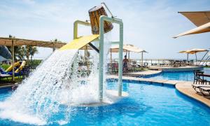 a water slide in a pool at a resort at Mishol Bodas Hotel & Beach Club Acapulco Diamante in Acapulco