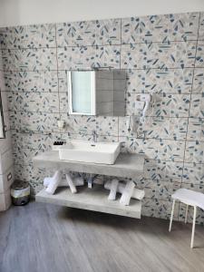 a bathroom with a sink and a mirror at Gradini Partenopei in Naples