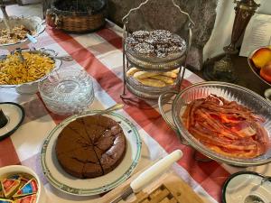 a table topped with different types of food and desserts at Dedek Park - historyczny dworek w pięknym Parku Skaryszewskim obok Stadionu Narodowego in Warsaw