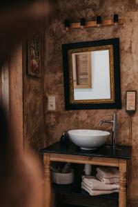 a bathroom with a sink and a mirror at La Chambre Rose in Durbuy