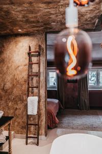 a room with a ladder next to a bedroom at La Chambre Rose in Durbuy +12 photos