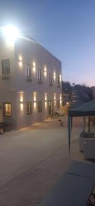 a large white building with the lights on at Ta' Gingel Farm Agriturisim B&B. Malta in St Paul's Bay