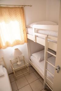 a small room with two bunk beds and a lamp at Bungalow Marina di Cortellazzo in Cortellazzo