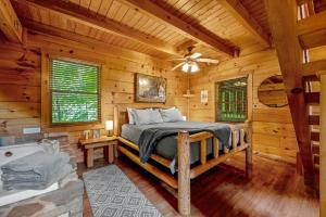 a bedroom with a bed in a log cabin at Sunrise Woods Retreat cabin in Sevierville