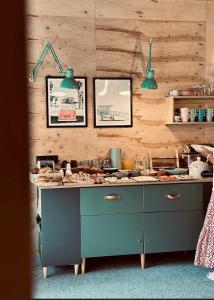 a kitchen with a counter with two green lights at 2 STODOŁY Chillout in Dziwnów