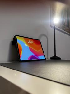 a tablet sitting on a table next to a lamp at City-Designapartment in Gaggenau