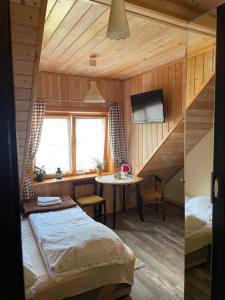 een kamer met een bed en een tafel in een kamer bij Jasminowe Wzgorze in Wilkanów