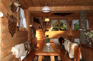 بينسجونات يو أني في زاكوباني: غرفة معيشة في كابينة خشبية مع طاولة وكراسي