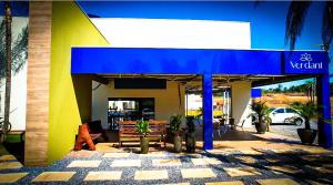 a restaurant with a blue awning on a building at Verdant hotel in Bonito