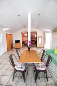 a dining room with a wooden table and chairs at GOLDEN SUN STUDIOS in Kallithea Halkidikis