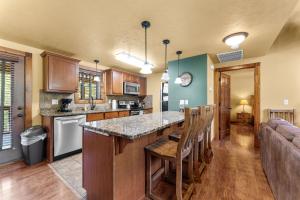 a kitchen with a large island in a living room at Makin Memories Lodge Cabin in Branson West