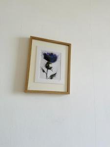 a picture of a flower on a wall at Gorgie Nook in Edinburgh