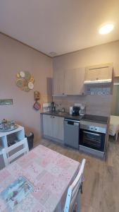 a kitchen with a table and a kitchen with a table and chairs at Villa de la dore in Le Mont-Dore