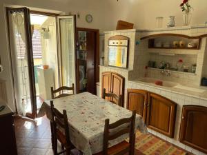 a kitchen with a table and a dining room at Il Nido del Gabbiano in Savona