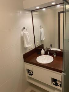 a bathroom with a sink and a mirror at Dunas de Cotovelo in Parnamirim