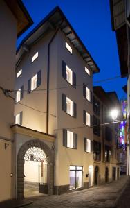 a large building with an archway next to a street at LE TORRI LOVERE in Lovere