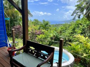a view of the ocean from a room with a tub at Bungalow avec vue dans lieu calme in Le Carbet