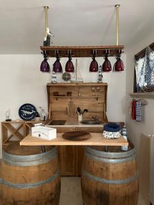 a kitchen with a table made out of wine barrels at Bougainville in San Vincenzo