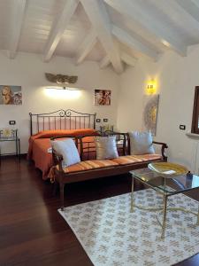 a bedroom with a bed and a couch and a table at Bougainville in San Vincenzo
