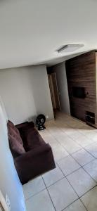 sala de estar con sofá en el suelo de baldosa en Apartamento Aconchegante en Goiânia