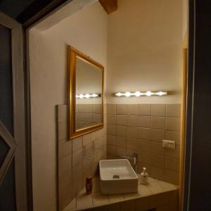 a bathroom with a sink and a mirror at Saint Mary Magdalene in Acqui Terme