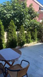 a table and two chairs sitting next to a street at Apartments Ivan in Petrovac na Moru
