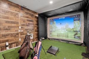 a room with a screen with a golf course on it at The Retreat at Buffalo Run Golf Course - Commerce City in Henderson
