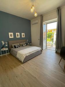 a bedroom with a large bed and a sliding glass door at Sunset 221 Cagliari in Cagliari