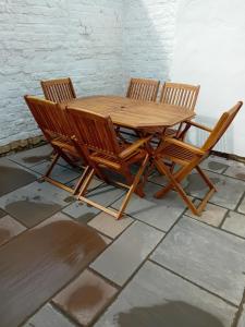 a wooden table and four chairs on a tile floor at SMUGGLERS HATCH in Marske-by-the-Sea