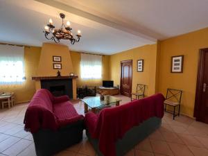 a living room with a couch and a table at Finca Los Molinos in La Alameda de Cervera