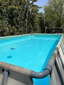 a blue swimming pool on a balcony with trees at Finca Los Molinos in La Alameda de Cervera