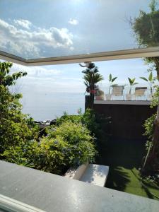 a view of the ocean from the balcony of a house at Luxury B&b Euphorbia in Acireale