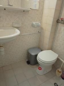 a small bathroom with a toilet and a sink at Стеди - стая за гости in Varna City