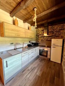 a kitchen with a sink and a refrigerator at Casa A Poza in Samos