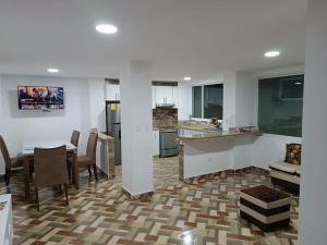 a kitchen and living room with a table and chairs at Residencia Chamorro-Dorado in Quito