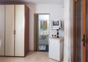 a bathroom with a sink and a television in it at B&B Moderno in Fažana +23 photos