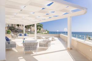 a patio with chairs and a view of the ocean at PALAZZO SAN ROCCO in Sperlonga