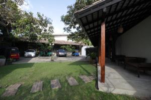 a patio with a yard with cars parked in a parking lot at Handagedara Resort & Spa in Mirissa