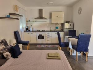 a kitchen and living room with a table and chairs at Studio apartment LENI in Banjole