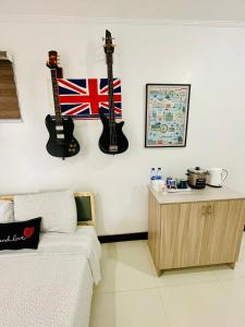 a bedroom with two guitars hanging on the wall at London Unit Tagaytay Wifi/Netflix/Parking in Tagaytay