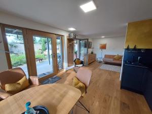 a living room with a couch and a table at kleine Schwarzwaldlodge in Efringen-Kirchen