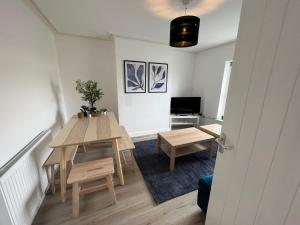 a living room with a table and chairs and a television at Littlehampton House - 4 bedroom house sleeps 8 in Littlehampton
