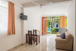 a living room with a couch and a table at Emerald Villas Weligama in Weligama