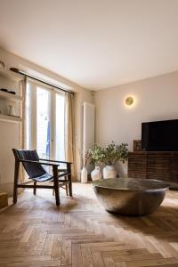 a living room with a large stone bowl on the floor at The Notting Hill Apartments By Hok Living - Nh1 in London