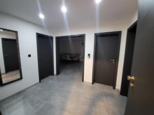 a hallway with black doors and a room with a table at Residenz 12 in Dinkelsbühl