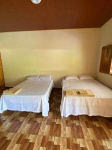 two beds sitting next to each other in a room at Hostal las 3 J in Suchitoto